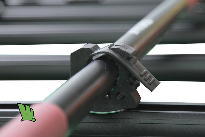 Close up of one fitting of the shovel holder with a shovel in place on a Wedgetail roof rack.