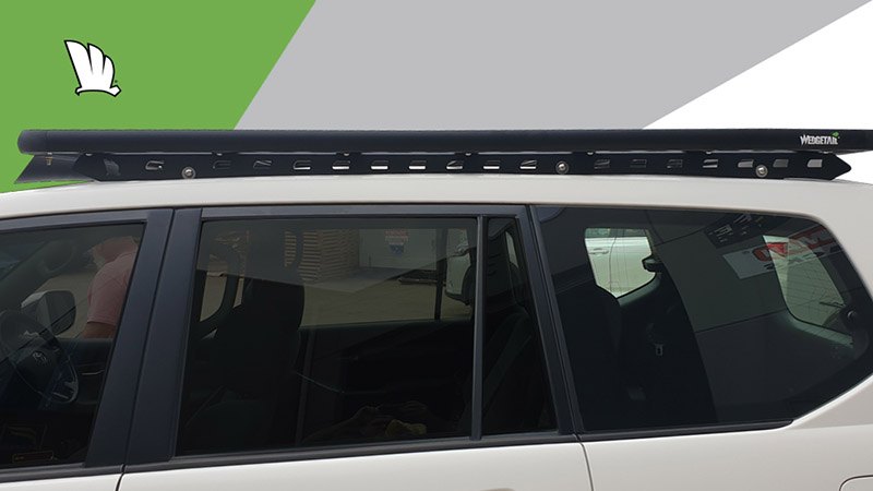 Side view of the Wedgetail rack on the Prado 120 Series showing the one piece mounting rails with three connection points and the platform roof rack attached to the mounting rails.
