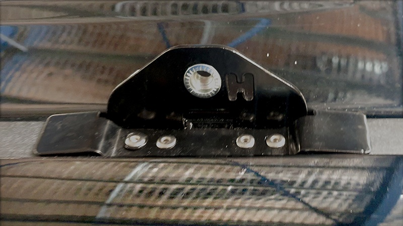 A mounting lug fitted to the roof of a vehicle using four stainless steel rivets.