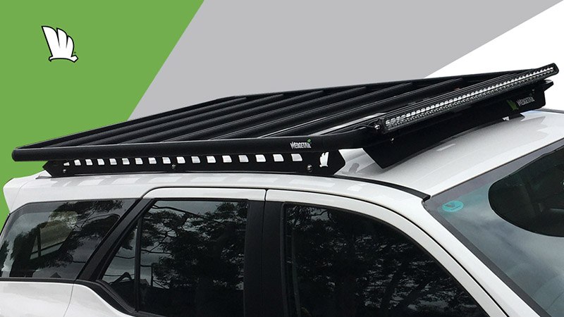 Front view of the Wedgetail rack on the Fortuner showing the owner installed light bar and our standard wind deflector, the mounting points for the one piece mounting rails and the platform on top with seven cross bars to give superior strength.