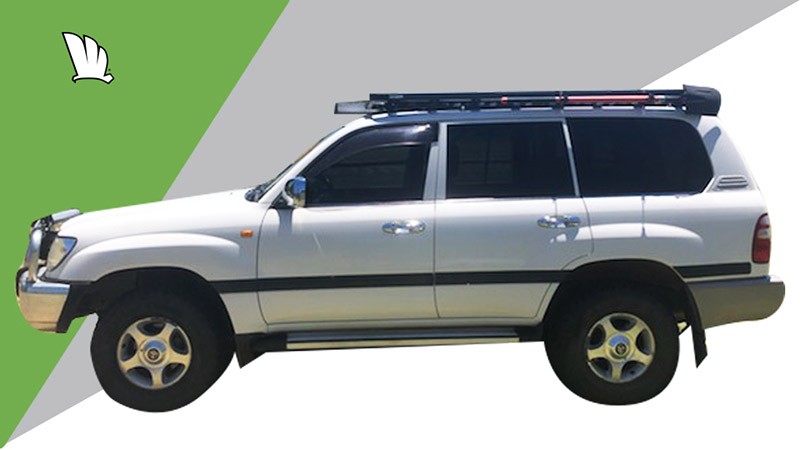 Side view of a Toyota LandCruiser 100 Series with a Wedgetail roof rack installed and with a shovel mount attachment on the side of the roof rack platform.