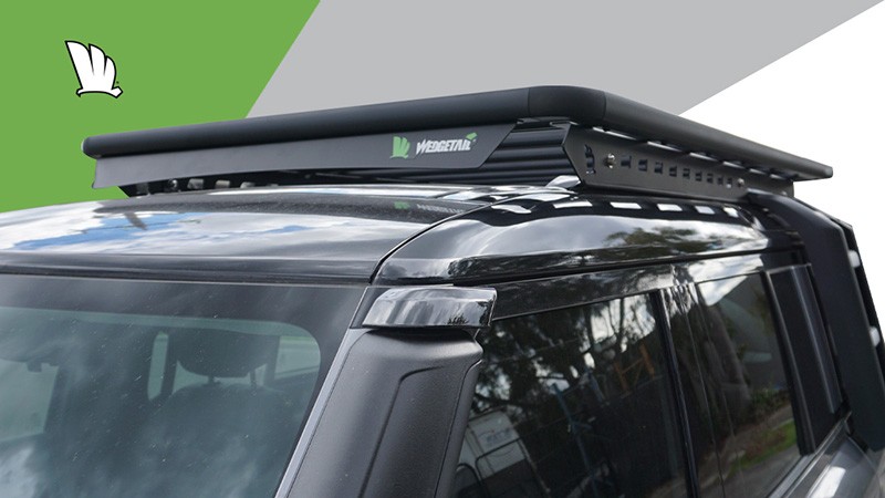 Front view of the Wedgetail platform roof rack, the one-piece mounting rails and the wind deflector mounted on the leading edge of the platform frame.