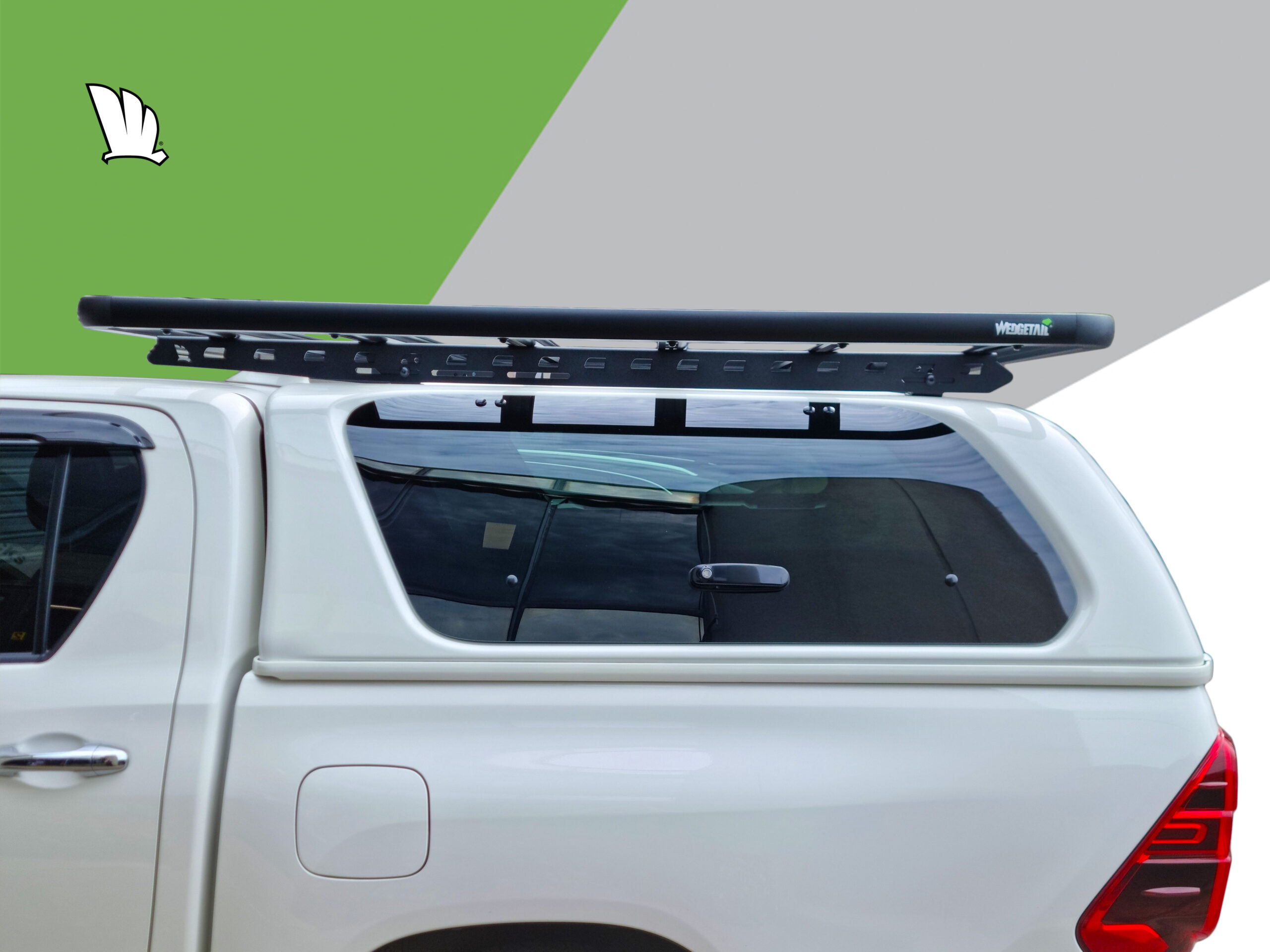 Side view of the Wedgetail rack on the cabin roof of the HiLux showing the one piece mounting rails with two connection points and the platform roof rack attached to the mounting rails at each of the five cross bars.